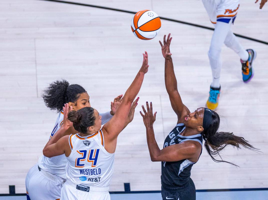 Aces guard Jackie Young (0) floats up a shot over Phoenix Mercury forward Kathryn Westbeld (24) ...