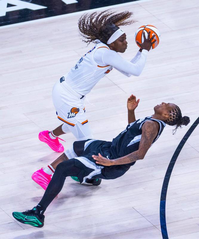 Aces guard Jewell Loyd (24) takes a hard charge to the face from Phoenix Mercury guard Kahleah ...