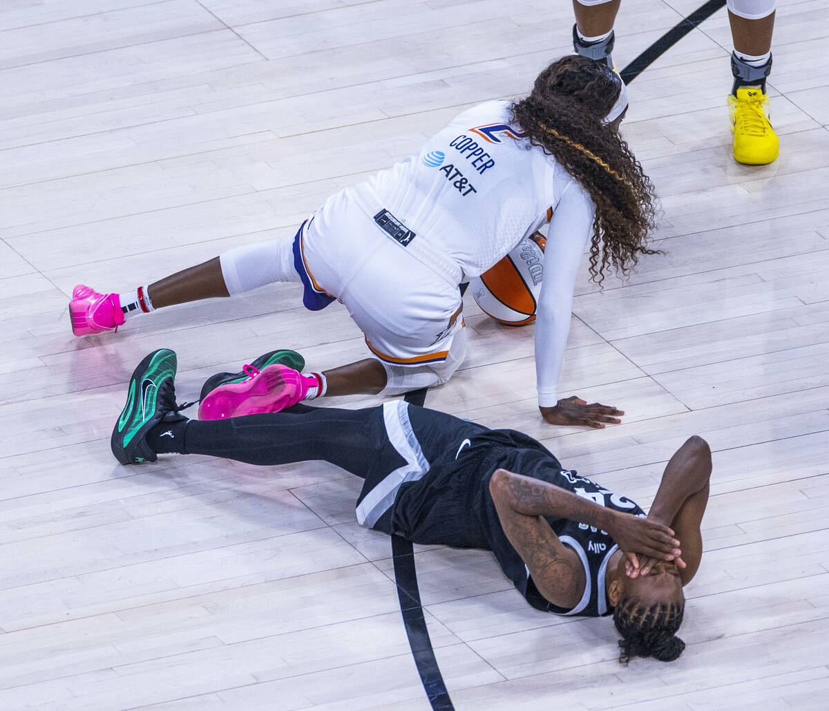 Aces guard Jewell Loyd (24) reacts to a hard charge to the face from Phoenix Mercury guard Kahl ...