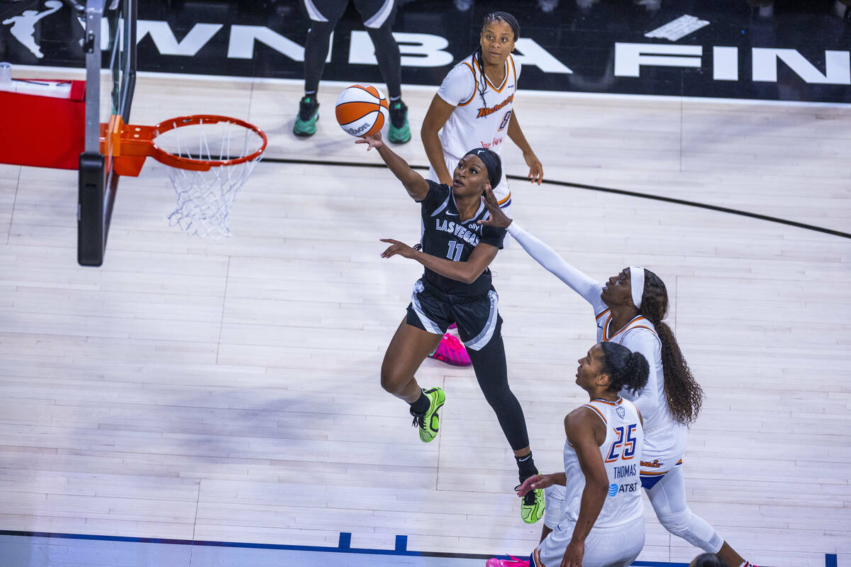 Aces guard Dana Evans (11) beats Phoenix Mercury guard Kahleah Copper (2) andforward Alyssa Tho ...