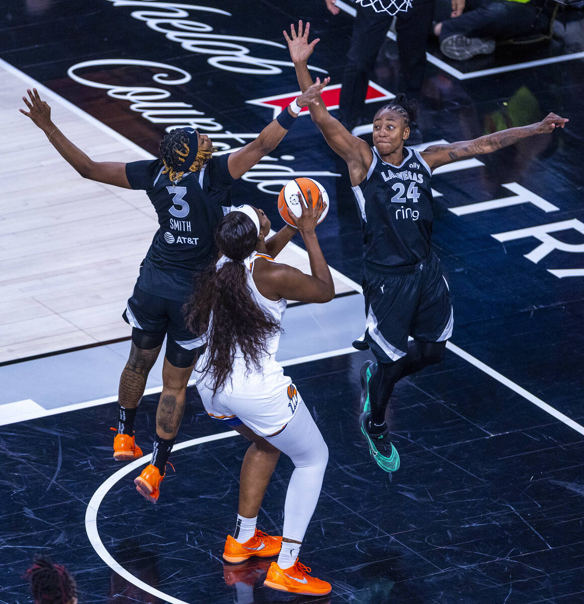 Phoenix Mercury center Kalani Brown (21) attempts to get off a shot with tight defense by Aces ...