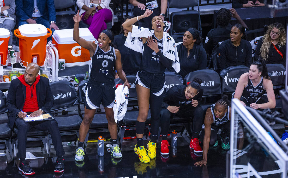 Aces guard Jackie Young (0) and center A'ja Wilson (22) with teammates on the bench late c ...