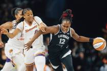 Aces guard Chelsea Gray (12) fights off Phoenix Mercury guard Monique Akoa Makani (8) as she dr ...