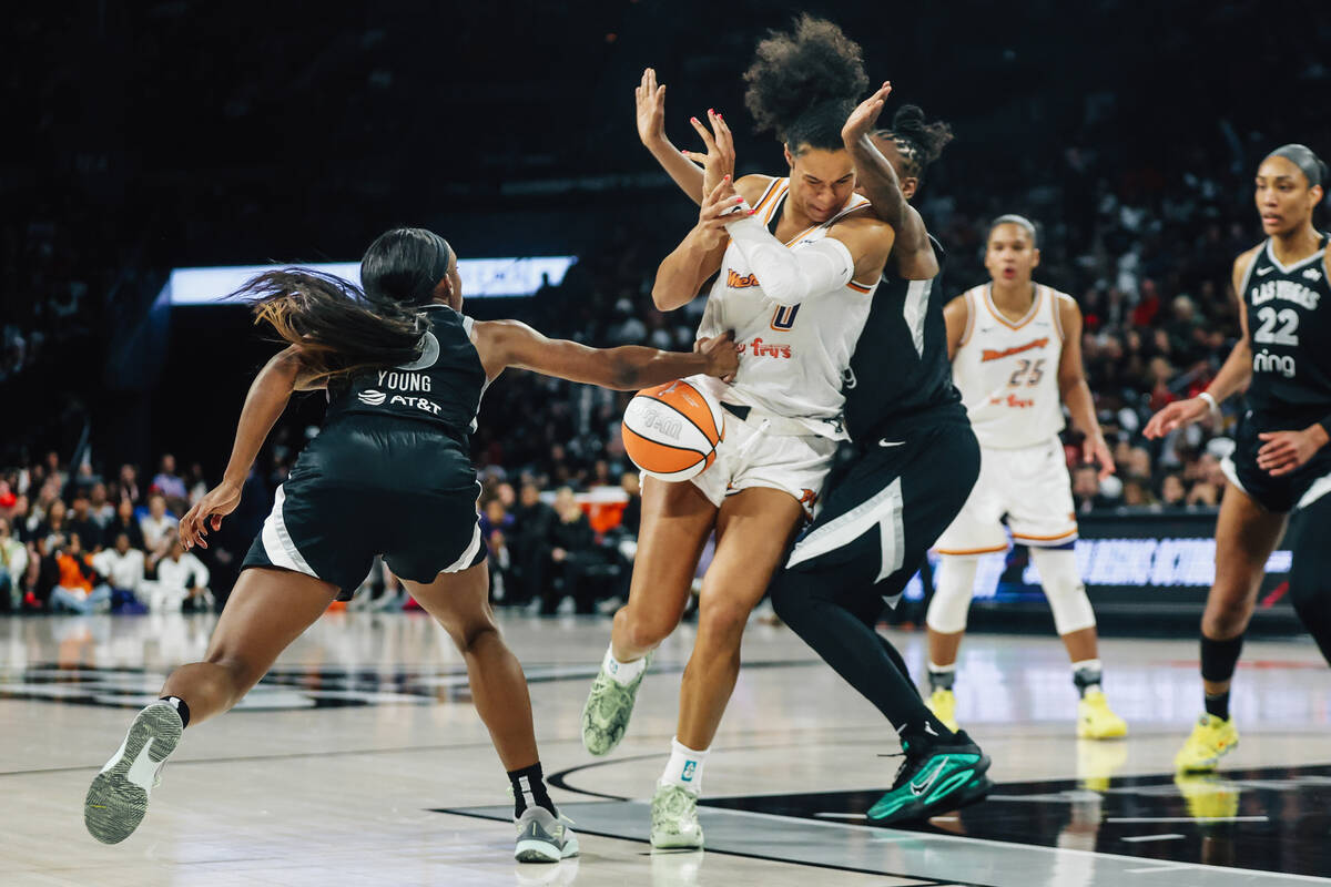 Phoenix Mercury forward Satou Sabally (0) braces as Aces guard Jackie Young (0) tries to steal ...