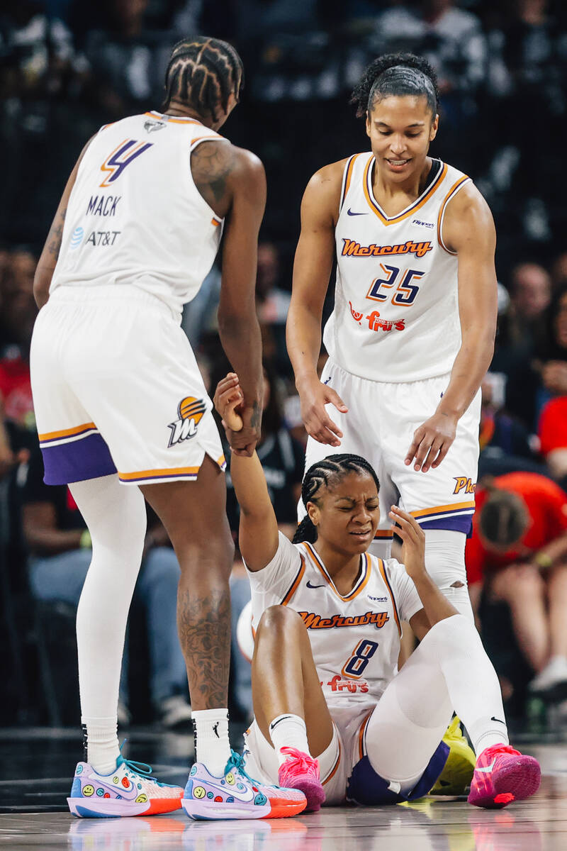 Phoenix Mercury forward Natasha Mack (4) and Phoenix Mercury forward Alyssa Thomas (25) help up ...