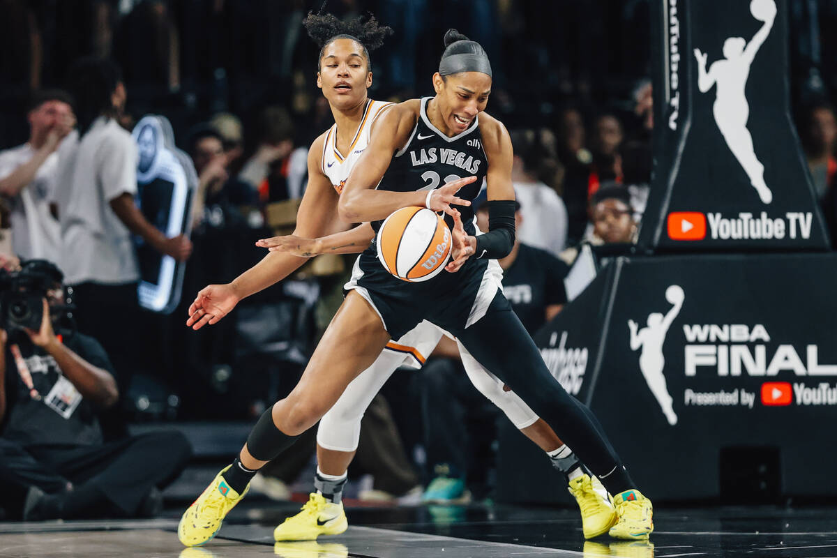 Aces center A'ja Wilson (22) works the ball as Phoenix Mercury forward Alyssa Thomas (25) ...