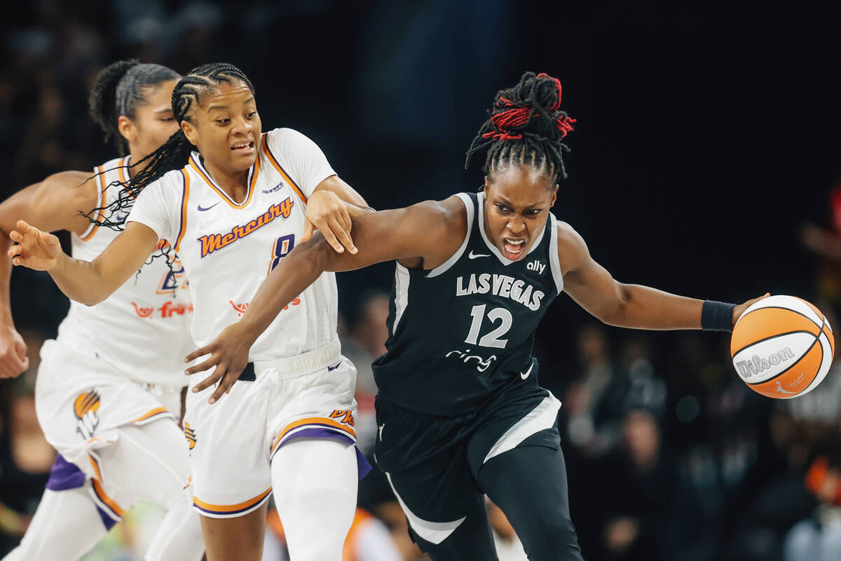 Aces guard Chelsea Gray (12) fights off Phoenix Mercury guard Monique Akoa Makani (8) as she dr ...