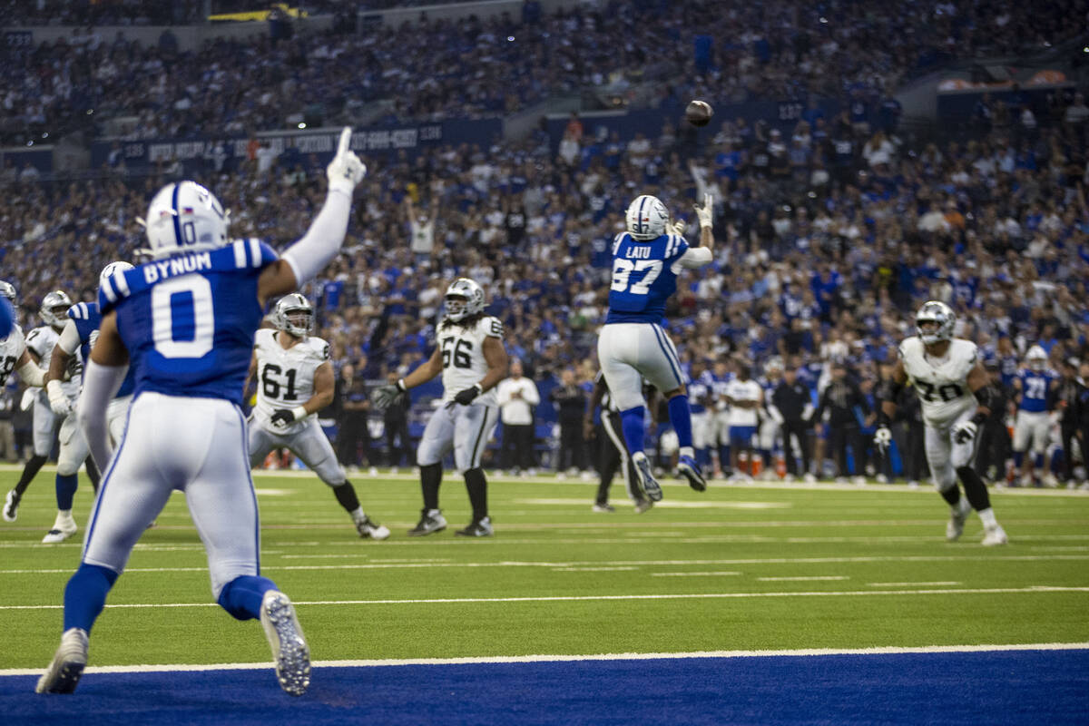 Indianapolis Colts defensive end Laiatu Latu (97) intercepts Raiders quarterback Geno Smith (7) ...