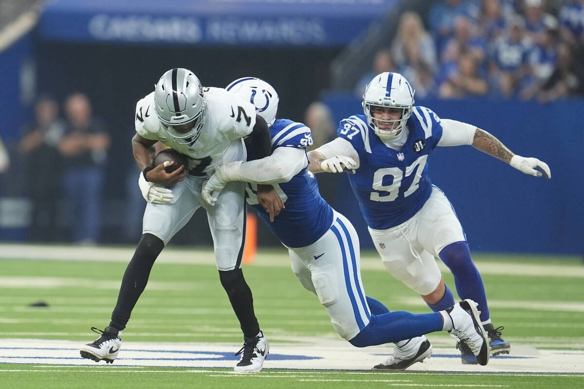 Las Vegas Raiders quarterback Geno Smith (7) is sacked by Indianapolis Colts defensive tackle D ...