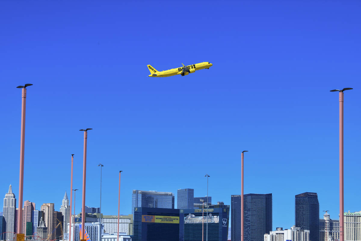 A Spirit Airlines jet takes off from Harry Reid International Airport with the Strip in the bac ...
