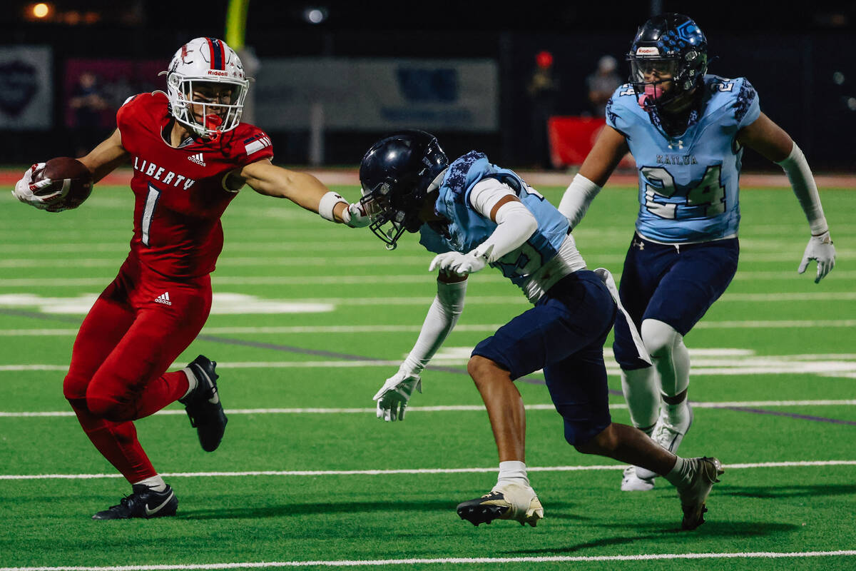 Liberty running back Ezra Sanelivi passes his opponents during a high school football game betw ...