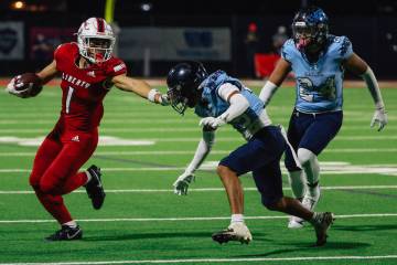 Liberty running back Ezra Sanelivi passes his opponents during a high school football game betw ...
