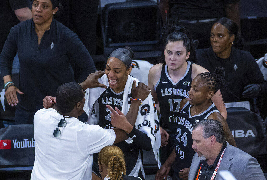 Aces center A'ja Wilson (22) shares a moment with Usher as he congratulates the team on an ...