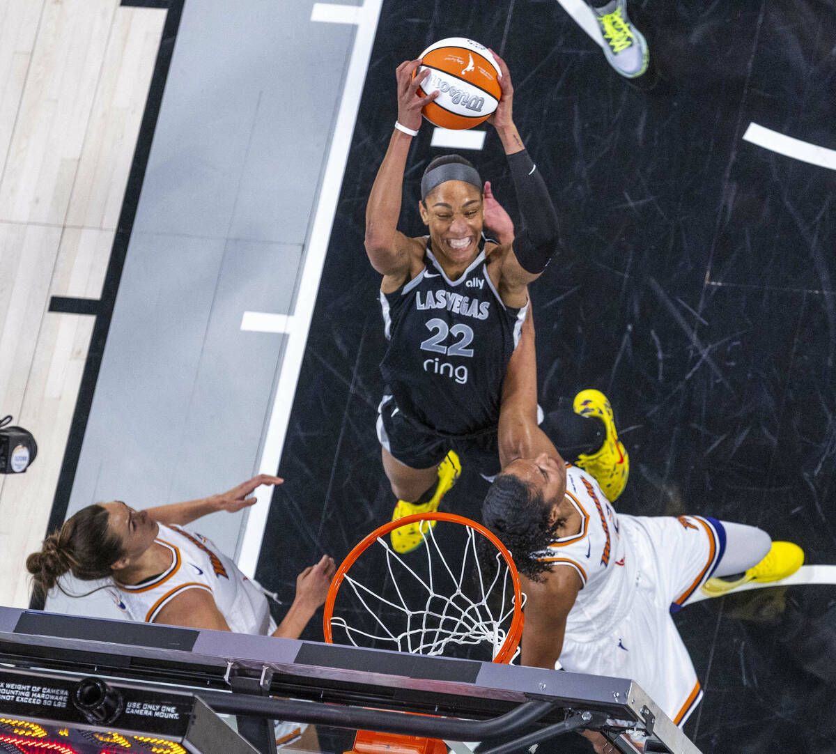 Aces center A'ja Wilson (22) posts up for a basket between Phoenix Mercury forward Kathryn ...
