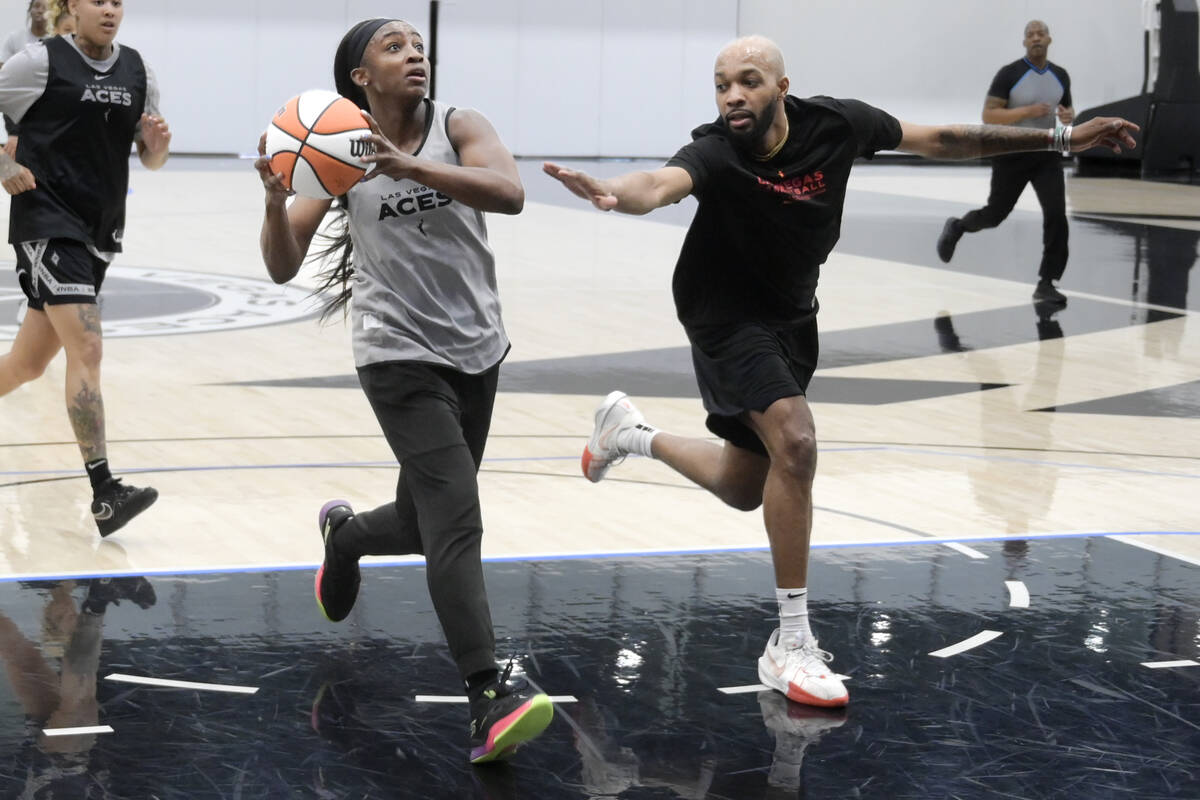 Las Vegas Aces practice player P.J. Savoy Jr. guards Jackie Young during the Aces first day of ...