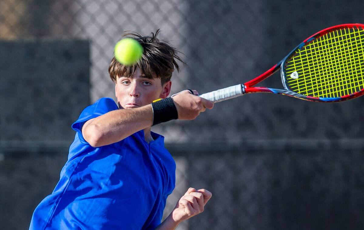 Bishop Gorman's Lucas Rago returns a ball against Faith Lutheran during their singles NIAA tenn ...