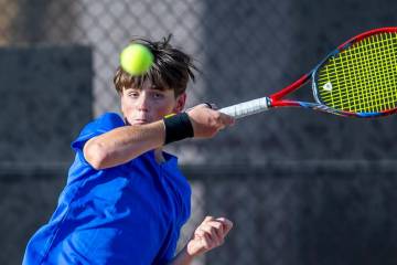 Bishop Gorman's Lucas Rago returns a ball against Faith Lutheran during their singles NIAA tenn ...