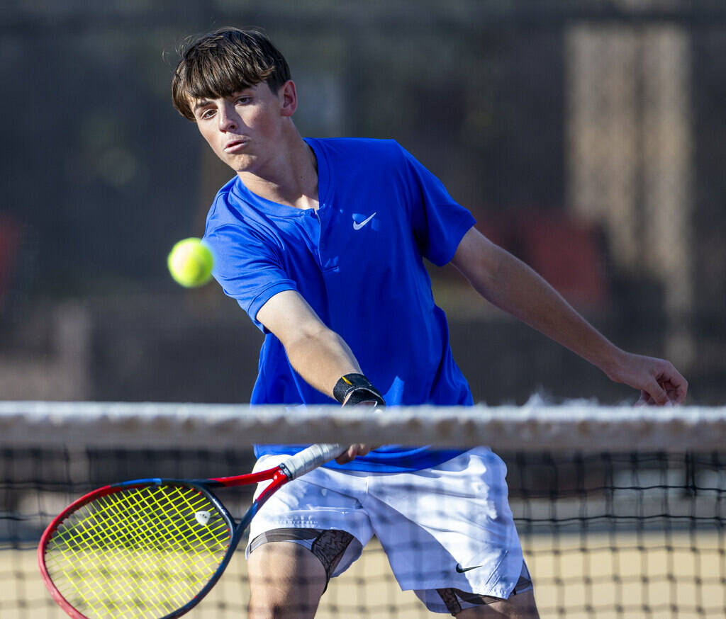 Bishop Gorman's Lucas Rago returns a ball against Faith Lutheran during their singles NIAA ...