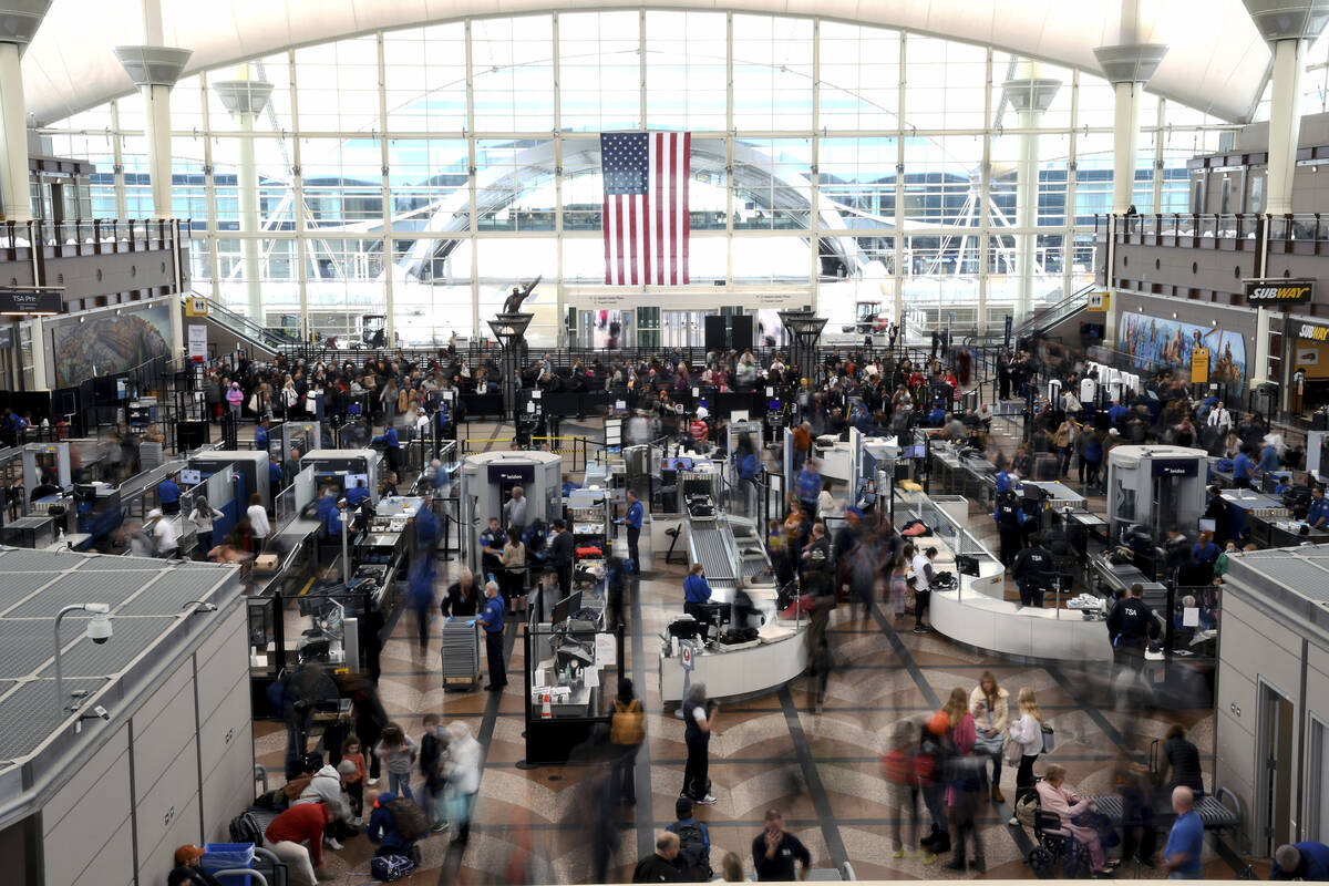 Passengers wait in a security line at Denver International Airport on Feb. 22, 2023. (AP Photo/ ...