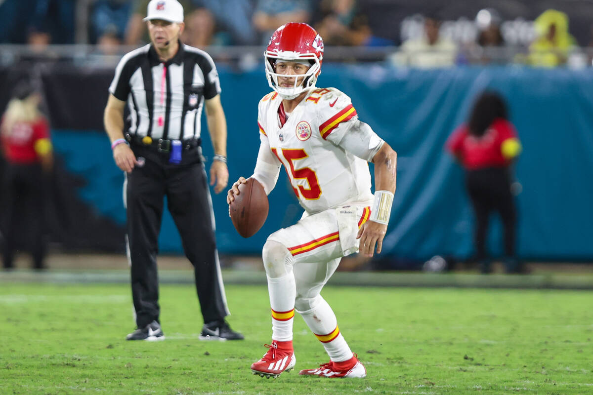 Kansas City Chiefs quarterback Patrick Mahomes (15) looks downfield during an NFL football game ...