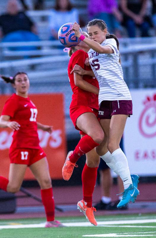 Faith Lutheran's Aylin Pierce (15) collides with a Coronado defender during the first half ...