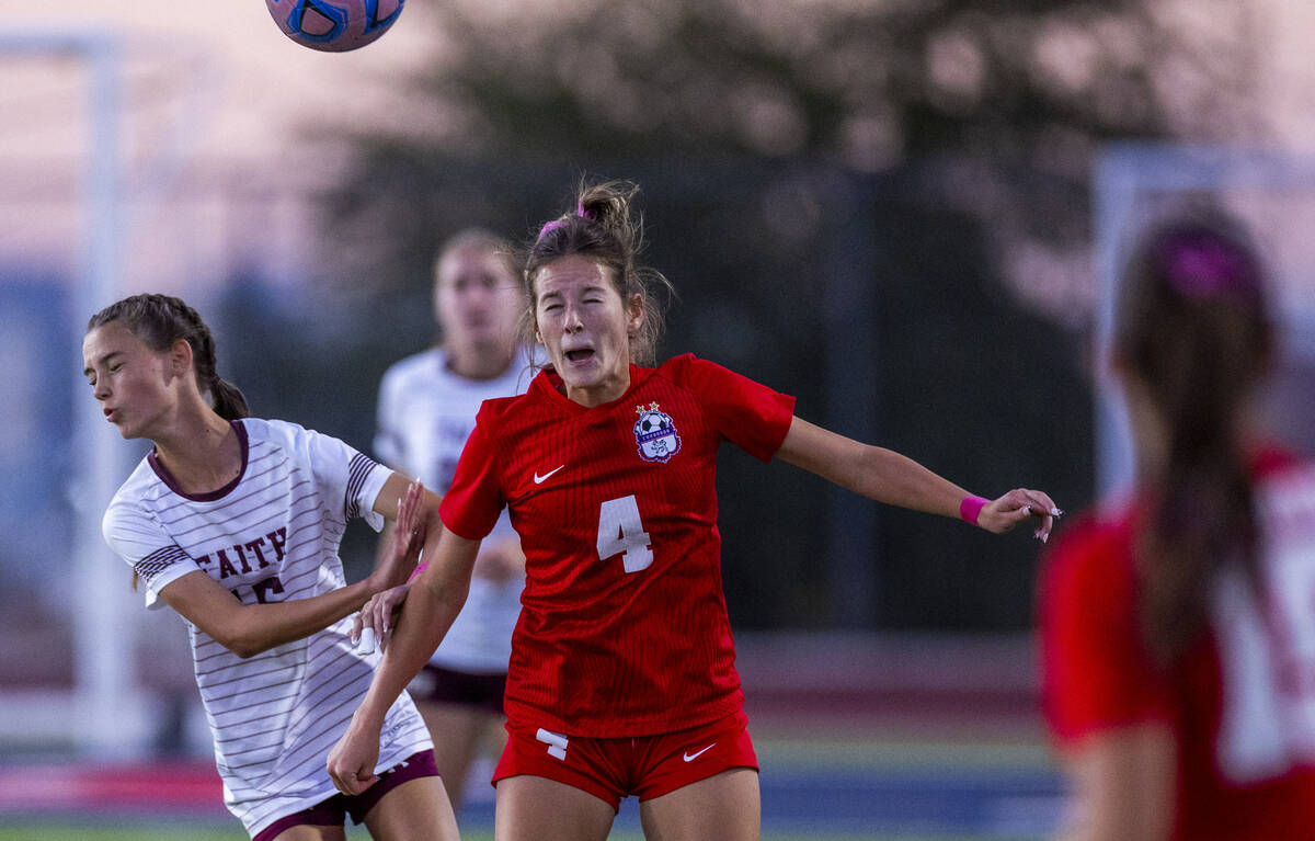 Faith Lutheran's Aylin Pierce (15) collides with Coronado's Ella Schultz (4) as she h ...