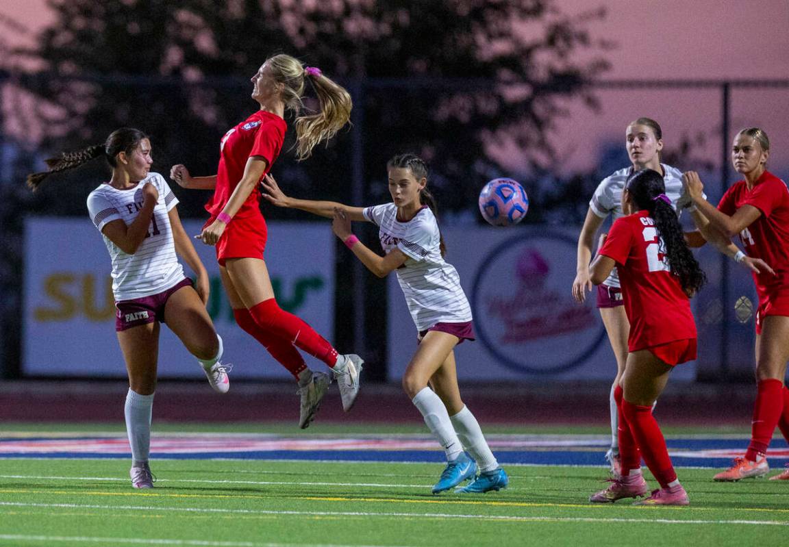 Coronado's Alexandra Milano (3) heads the ball past Faith Lutheran's Ana Coe (11) and ...