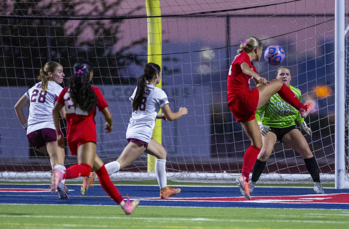 Coronado's Allison Kleiner (14) makes a goal shot against Faith Lutheran goalie Olivia Pet ...