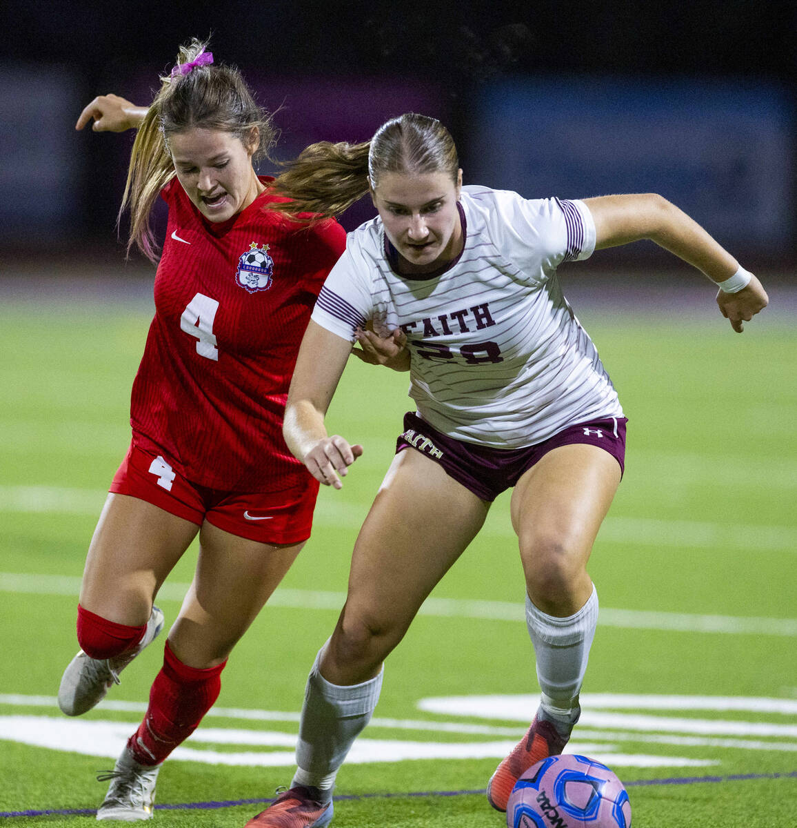 Coronado's Ella Schultz (4) battles for the ball with Faith Lutheran's Allie Rabe (28 ...