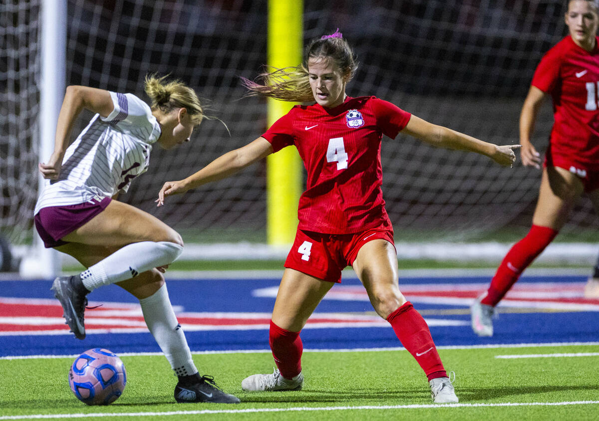 Faith Lutheran's Kloe Abdalla (14) attempts to get past Coronado's Ella Schultz (4) f ...