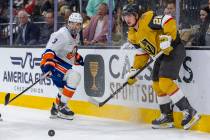 Golden Knights right wing Alexander Holtz (26) and New York Islanders defenseman Adam Pelech (3 ...