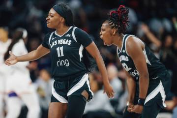 Aces guard Dana Evans (11) and Aces guard Chelsea Gray (12) celebrate during game one of a WNBA ...