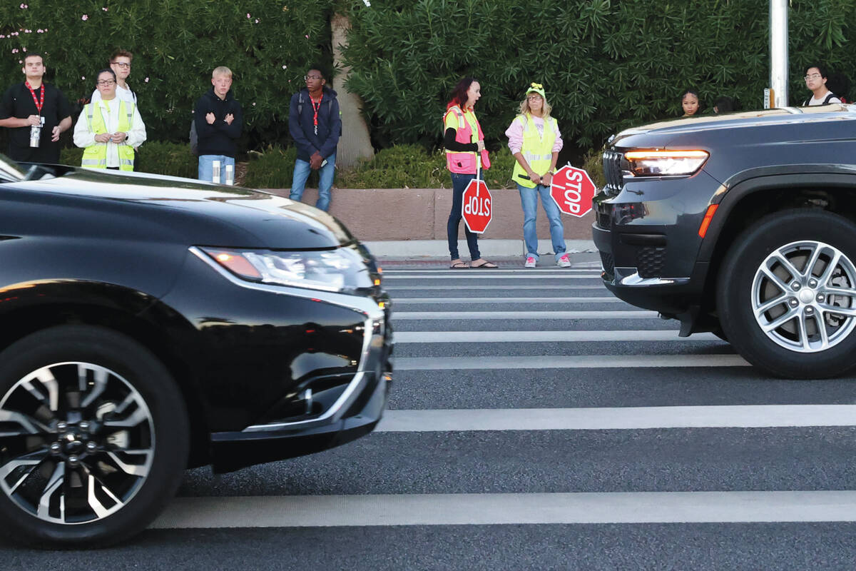 Bethany Limov, a volunteer with Walk Safely LV, left, talks with a paid crossing guard, who dec ...
