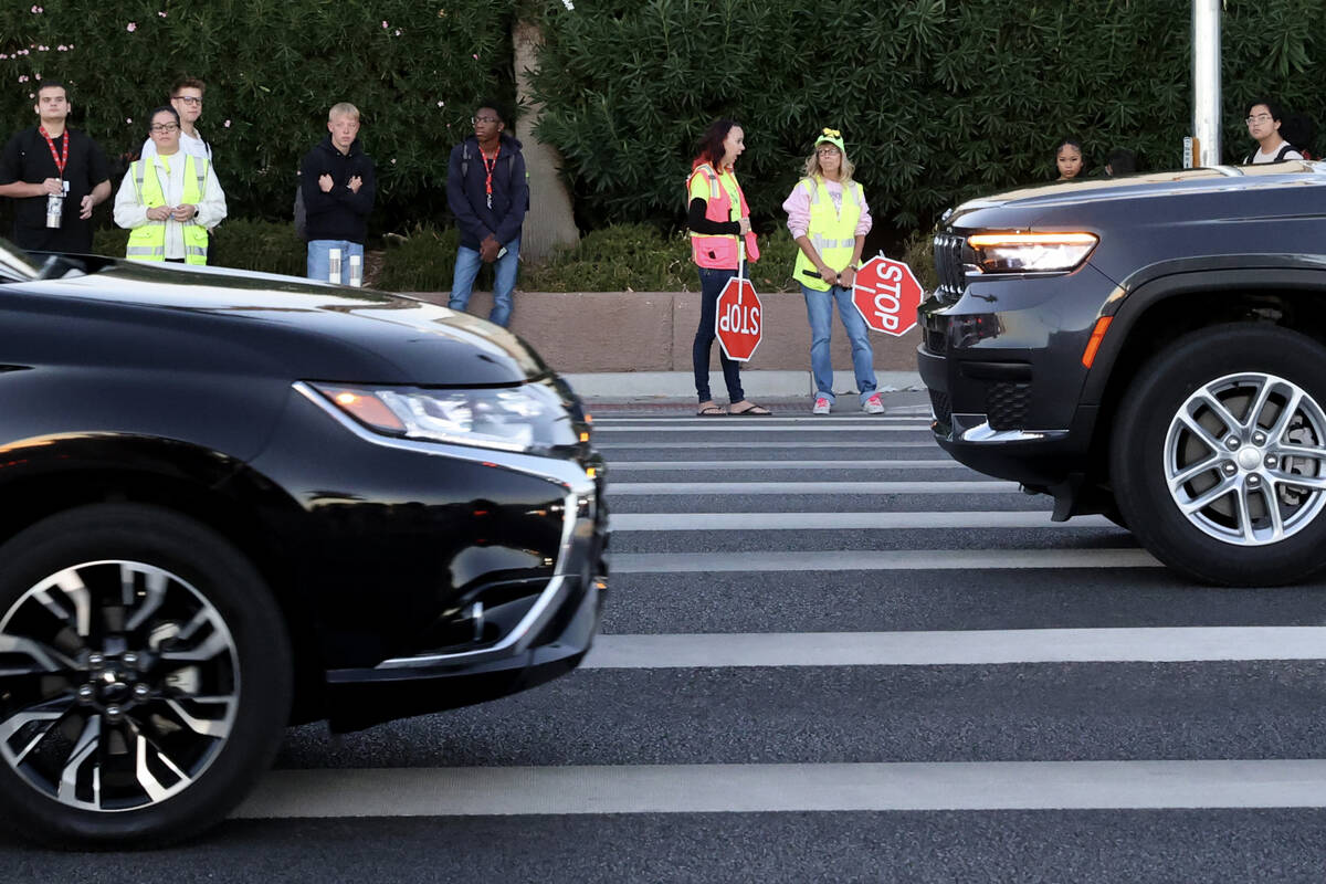 Bethany Limov, a volunteer with Walk Safely LV, left, talks with a paid crossing guard, who dec ...