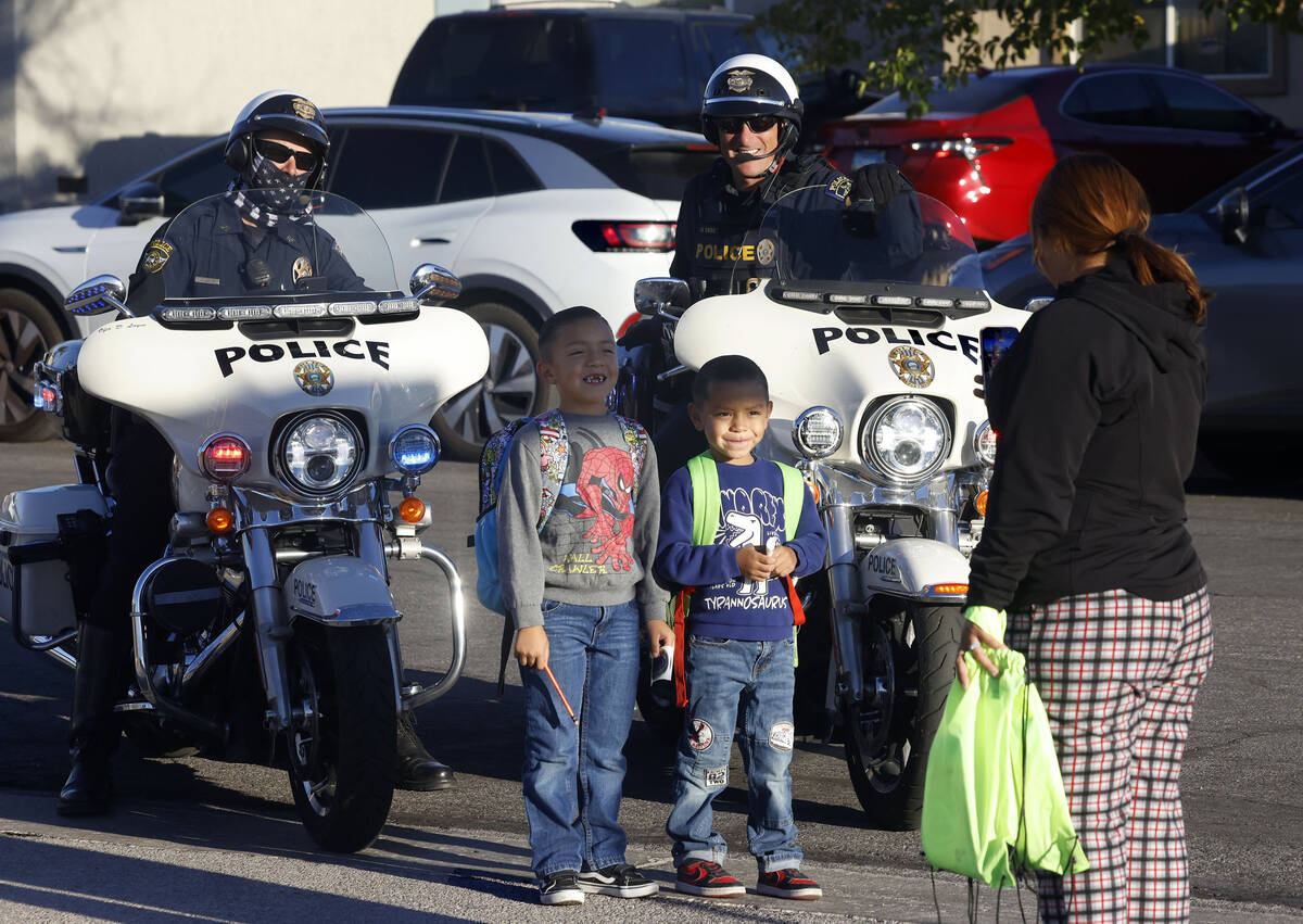 Karen Romero takes a picture of her children Thiago, 7, left, and Sebastian, 5, as they pose in ...