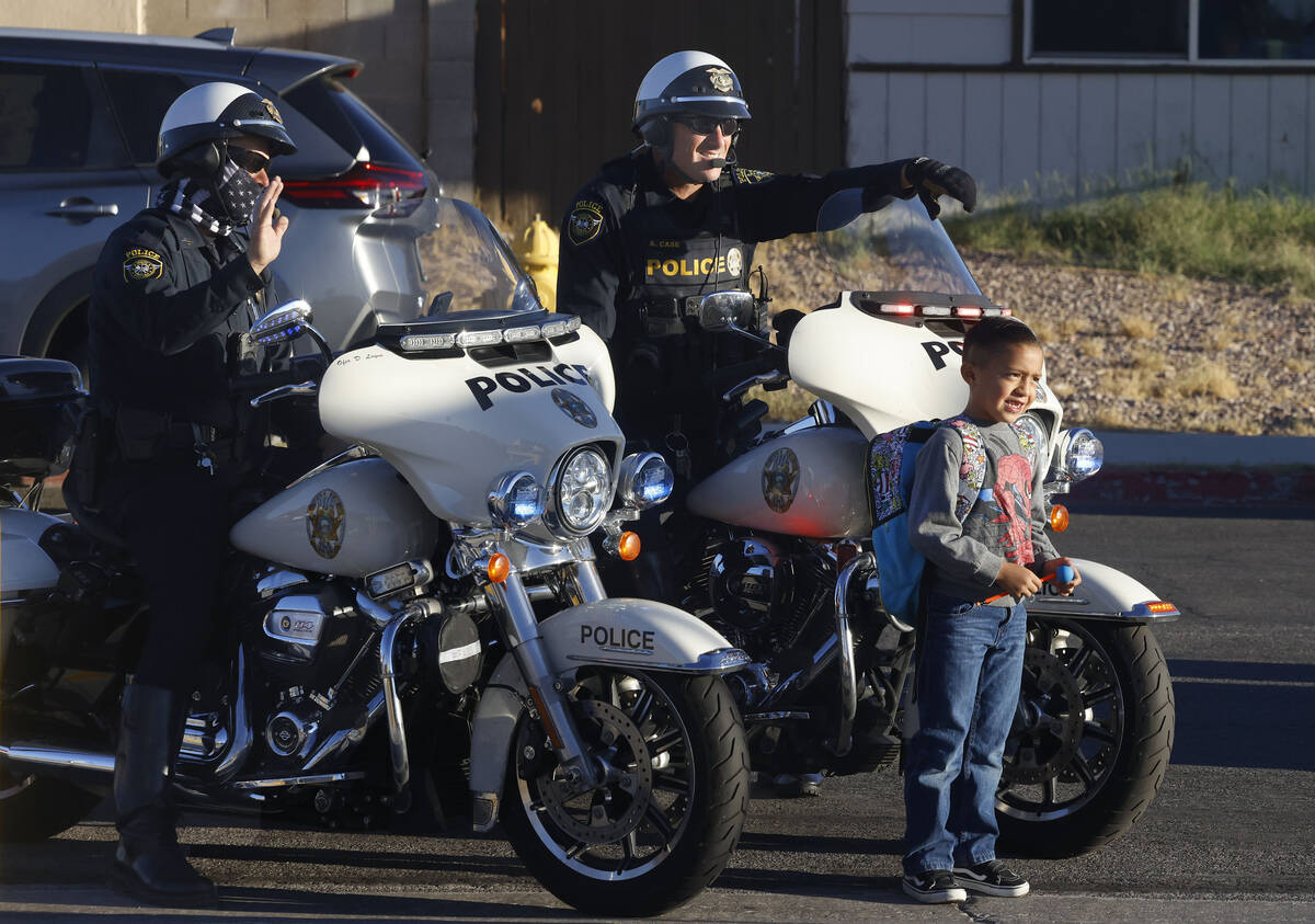 Thiago Romero, 7, poses for a photo in front of members of the Clark County School District Pol ...