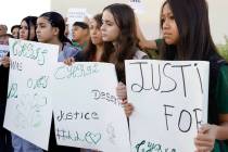 Classmates of a 12-year-old boy who was killed in a hit-and-run crash hold signs as they join p ...