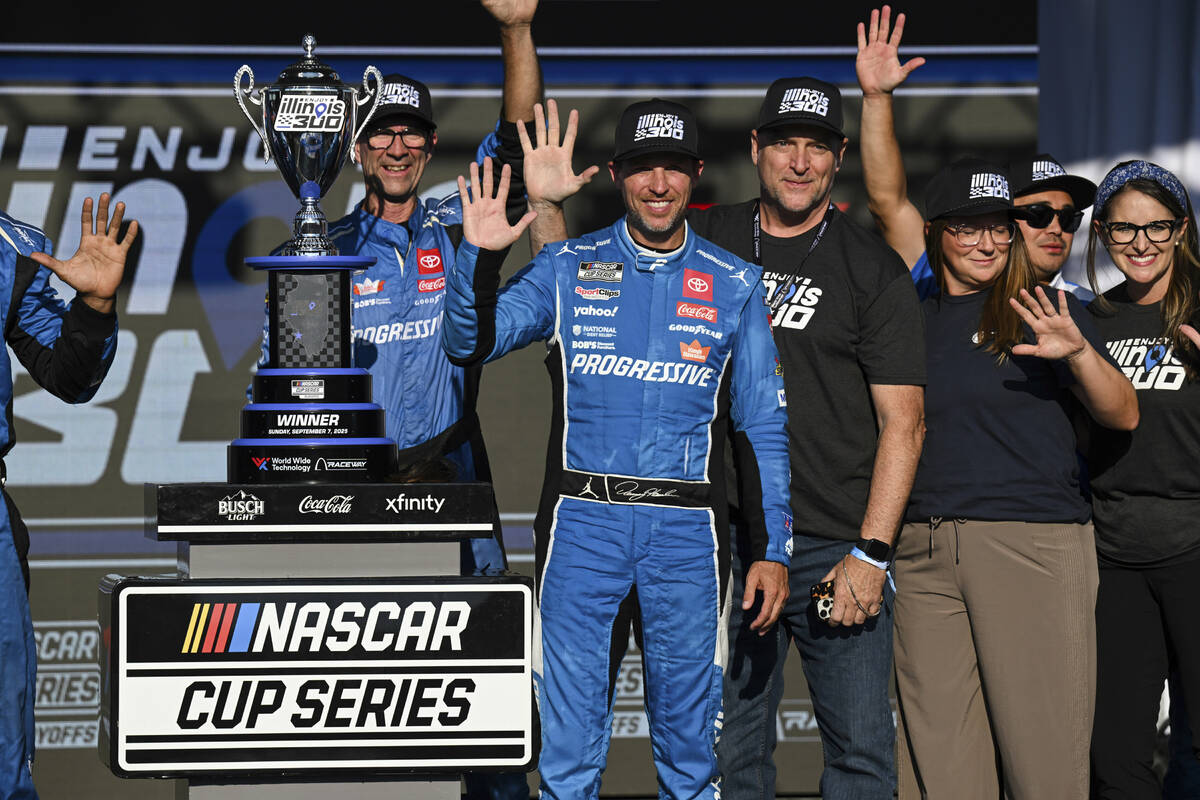 Denny Hamlin, center, celebrates after winning a NASCAR Cup Series auto race at World Wide Tech ...