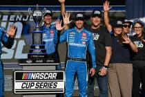 Denny Hamlin, center, celebrates after winning a NASCAR Cup Series auto race at World Wide Tech ...