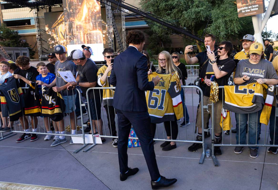 Golden Knights right wing Mark Stone (61) signs items for fans while walking the gold carpet ah ...
