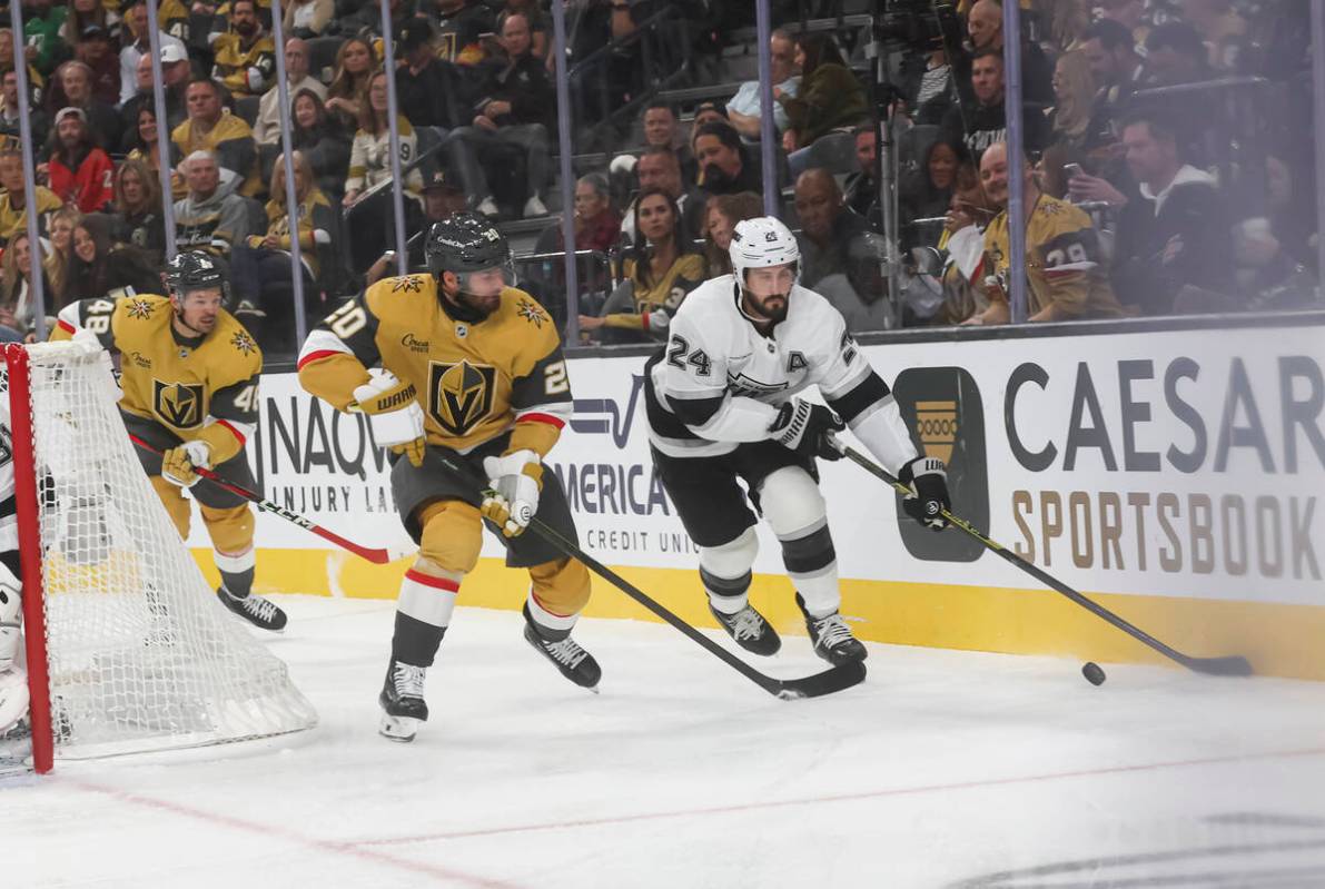 Los Angeles Kings center Phillip Danault (24) skates with the puck under pressure from Golden K ...