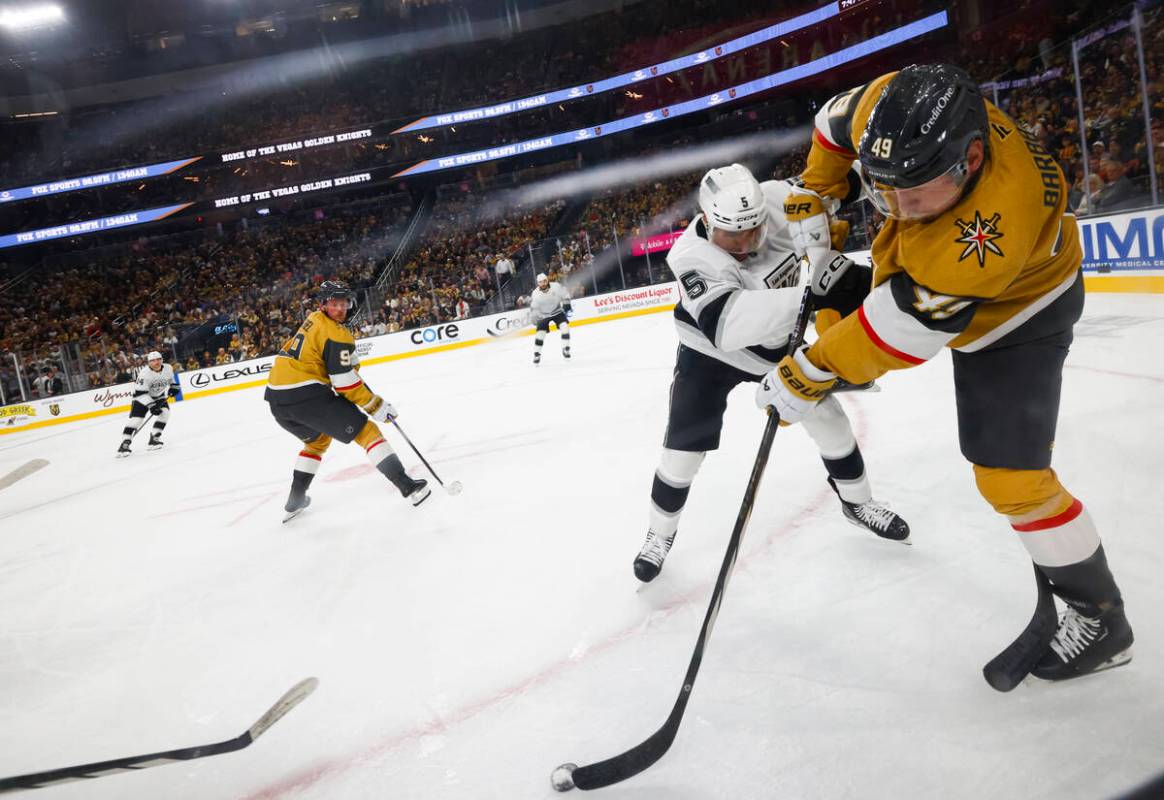 Golden Knights left wing Ivan Barbashev (49) passes the puck under pressure from Los Angeles Ki ...