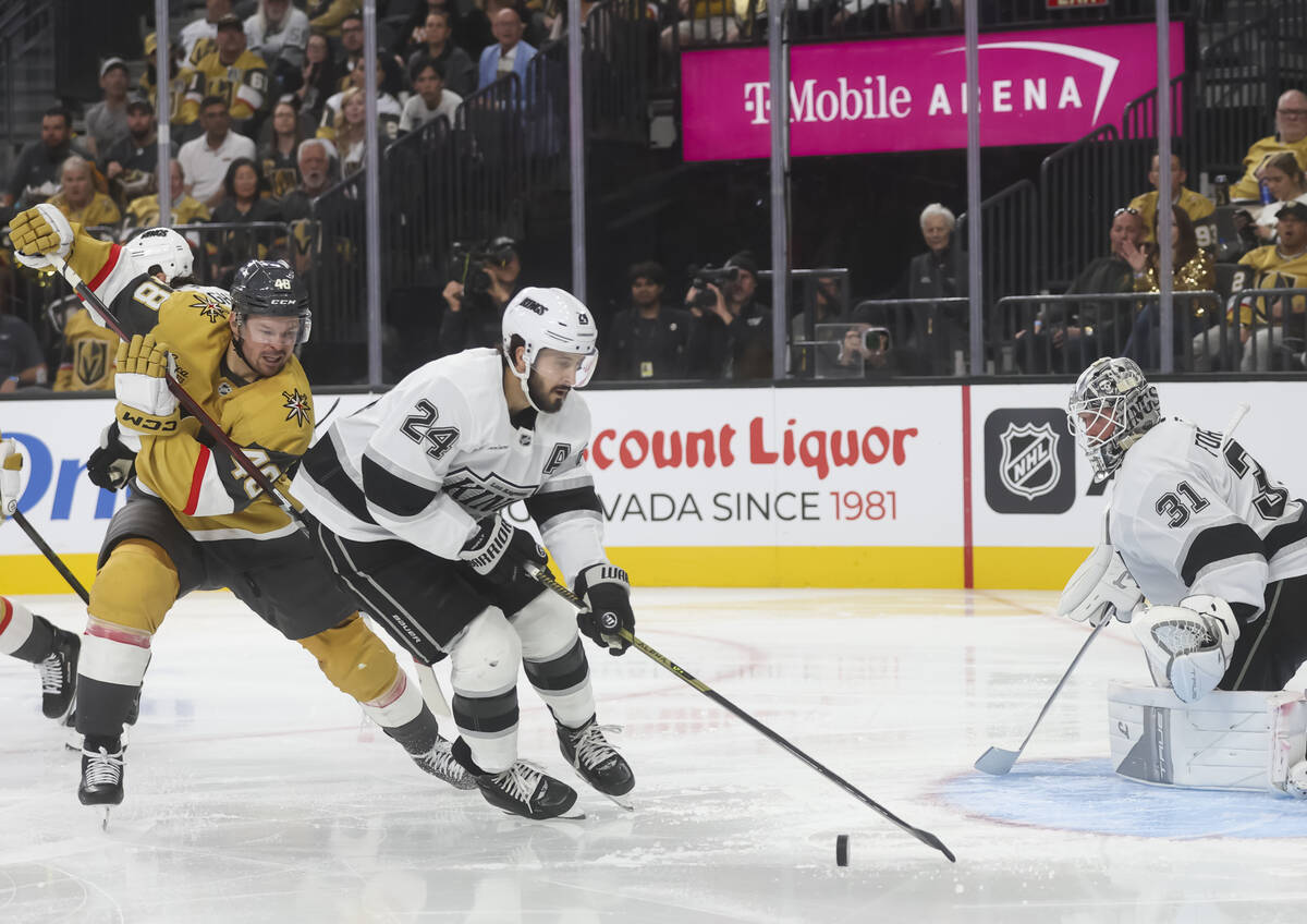 Los Angeles Kings center Phillip Danault (24) looks to clear the puck under pressure from Golde ...