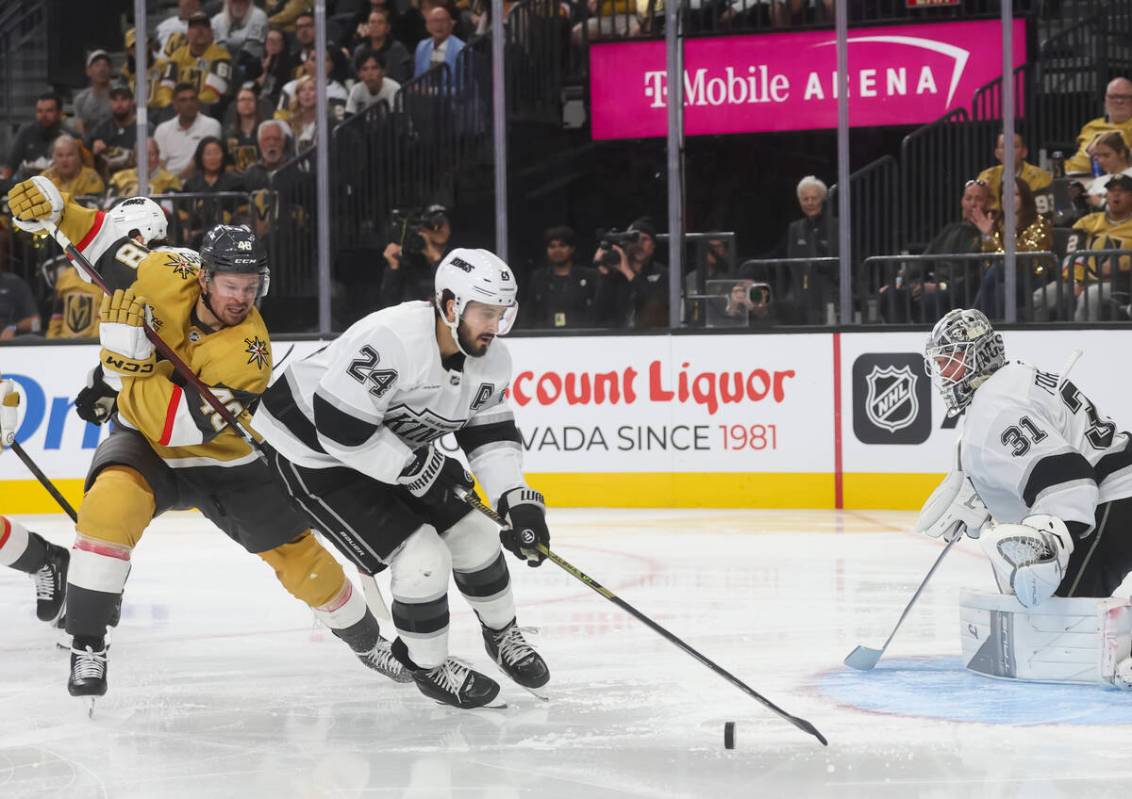 Los Angeles Kings center Phillip Danault (24) looks to clear the puck under pressure from Golde ...