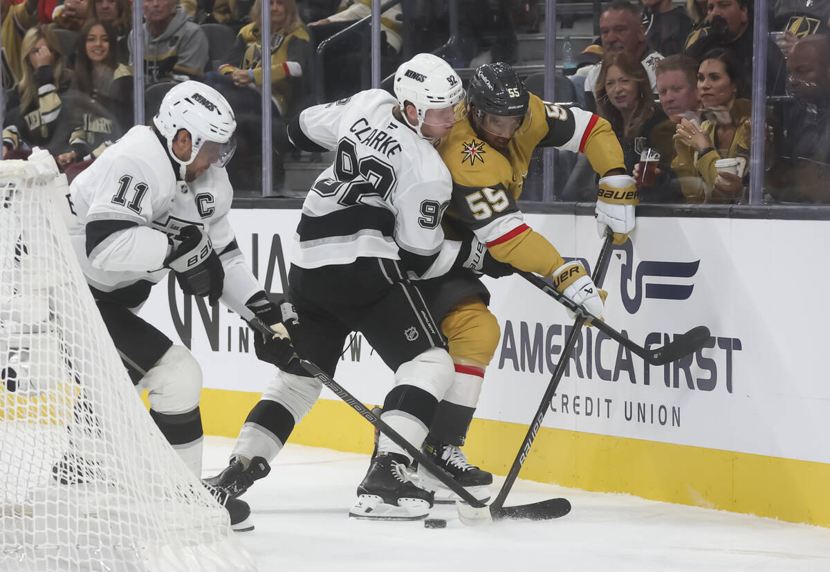 Golden Knights right wing Keegan Kolesar (55) passes the puck under pressure from Los Angeles K ...