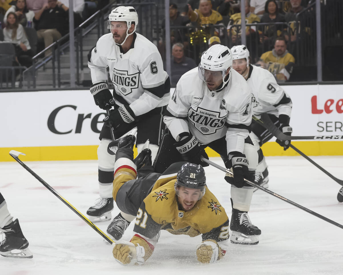 Golden Knights center Brett Howden (21) gets tripped up in front of Los Angeles Kings center An ...