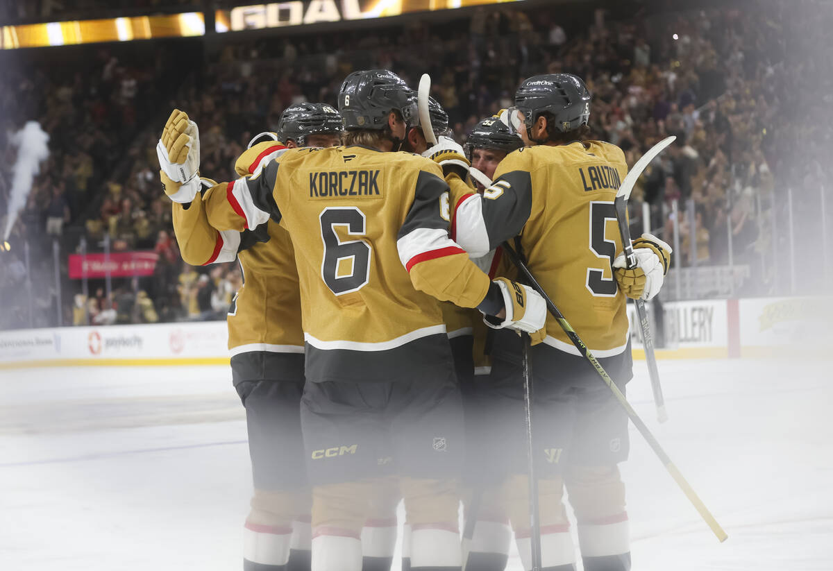 The Golden Knights celebrate a goal by Golden Knights center Jack Eichel, obscured, during the ...