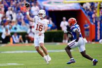 Texas quarterback Arch Manning (16) throws a pass as Florida linebacker Jaden Robinson, right, ...