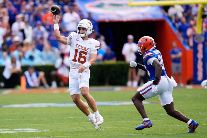 Texas quarterback Arch Manning (16) throws a pass as Florida linebacker Jaden Robinson, right, ...