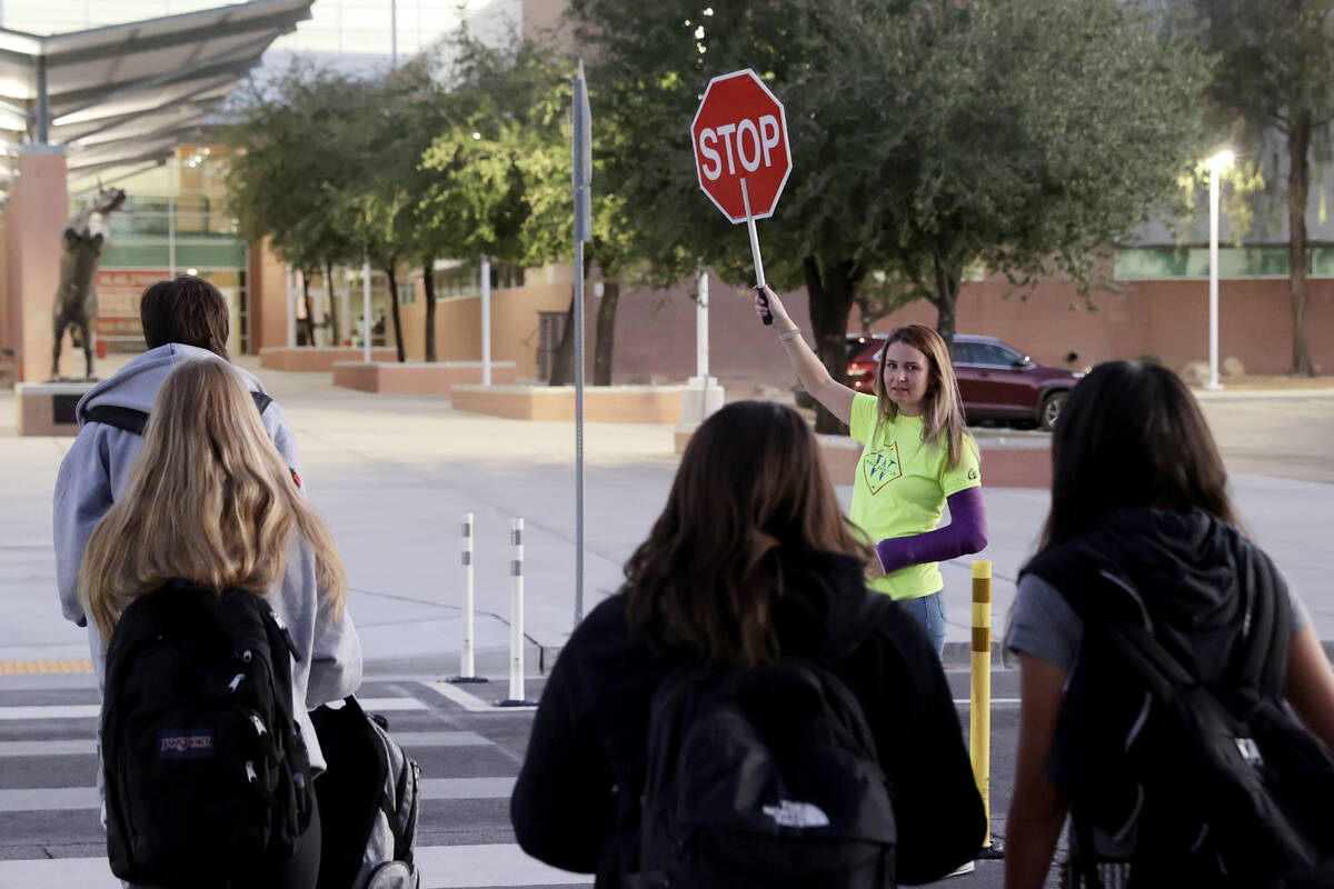 Ashley Brewer, a volunteer with Walk Safely LV, helps students get to school safely at Arbor Vi ...
